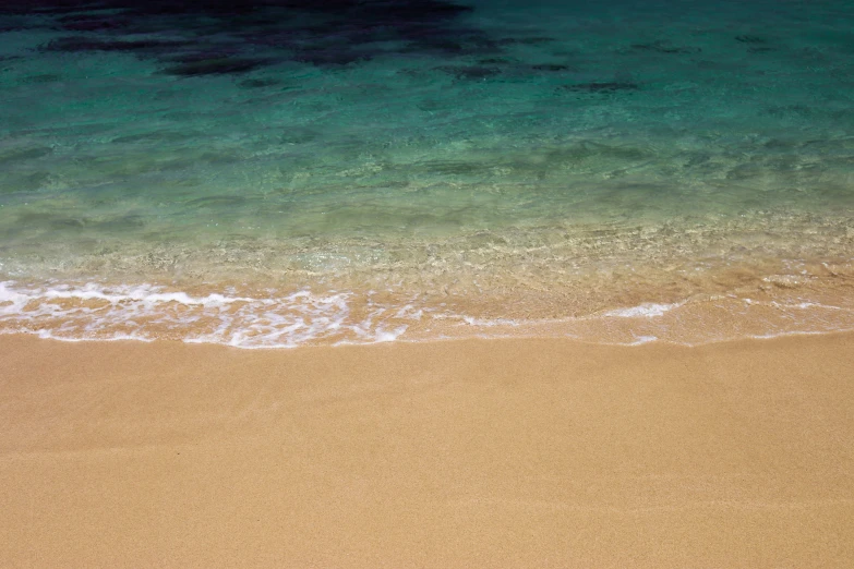 a white surf board laying on the beach