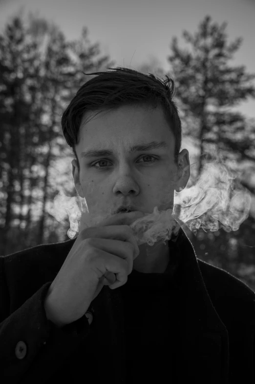 a boy is standing in the forest eating soing