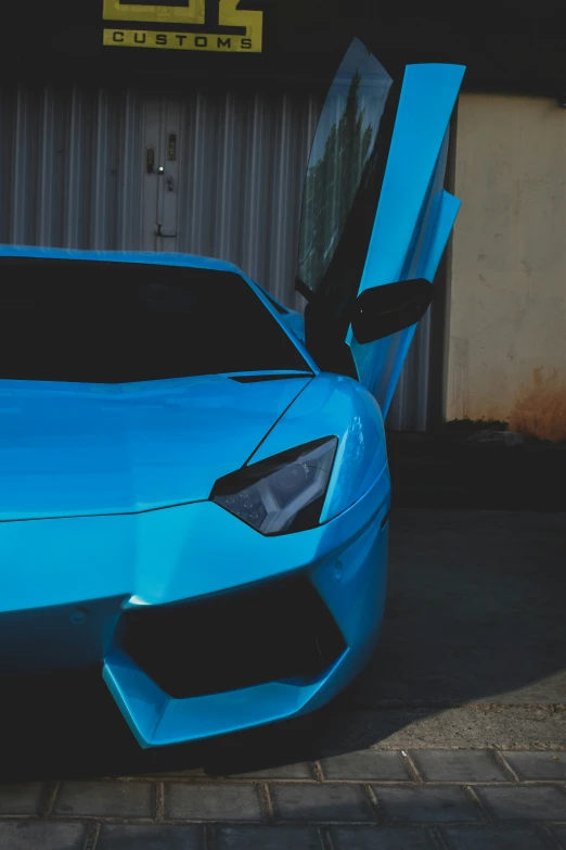 a blue sport car with its door open