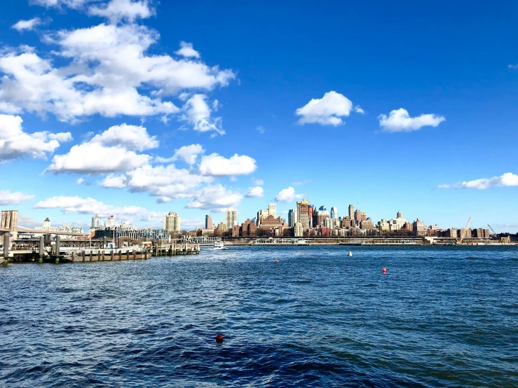 a city in a blue sky with some clouds