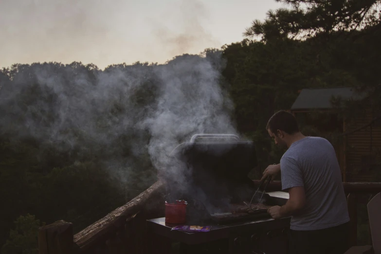 the man is grilling food on the barbecue