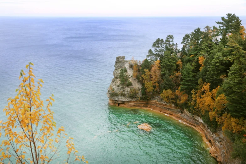 a body of water with rocks and trees around it