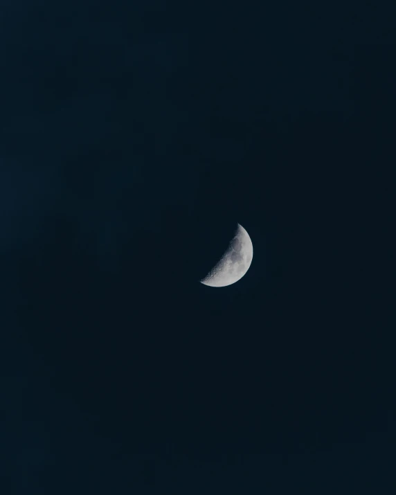 a half moon seen through a dark sky