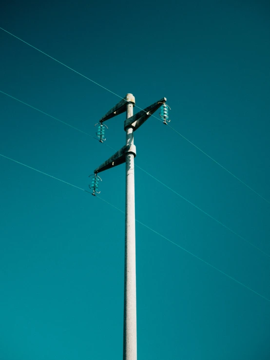 streetlights and power lines with blue sky