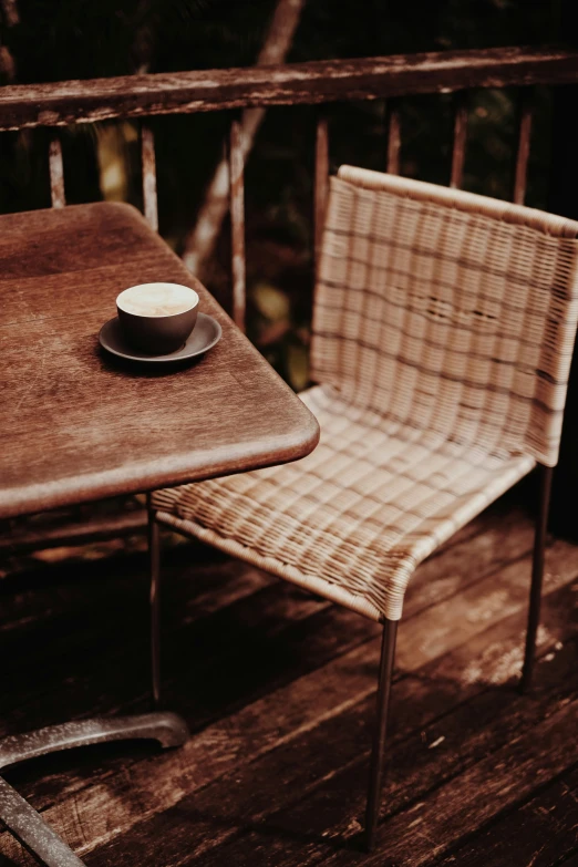 a brown table and chairs on the back deck