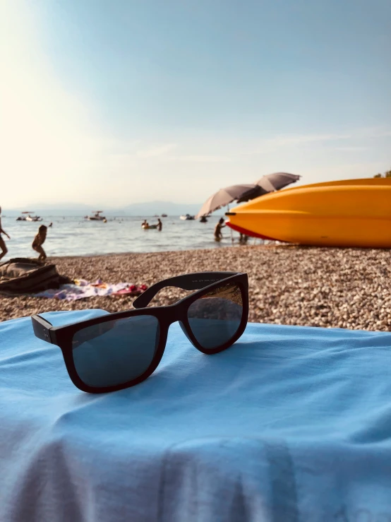 there is one pair of sunglasses sitting on top of a beach towel