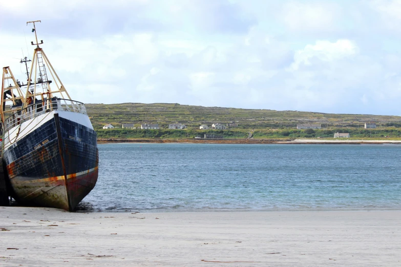 a large boat docked at the edge of the ocean