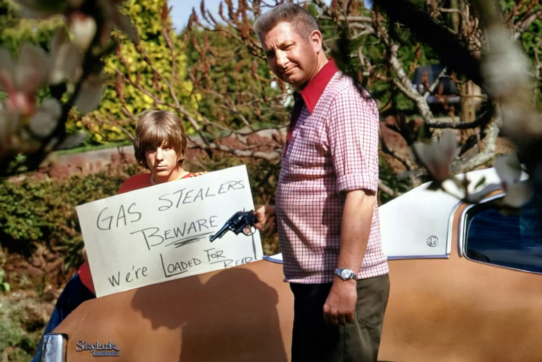 a man standing next to a  holding a sign