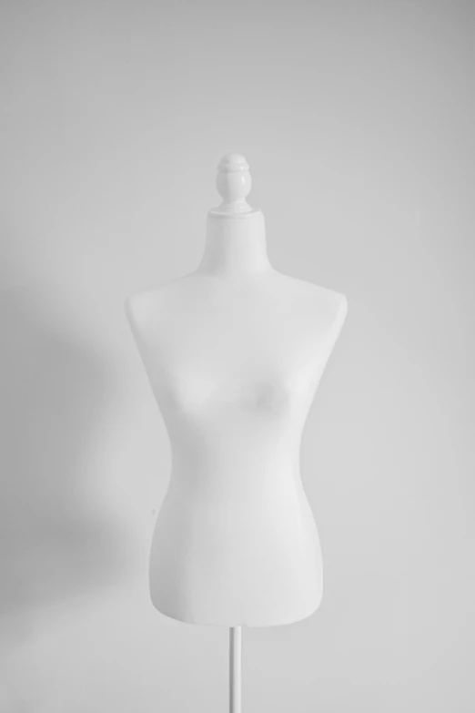 a white mannequin with no head on display