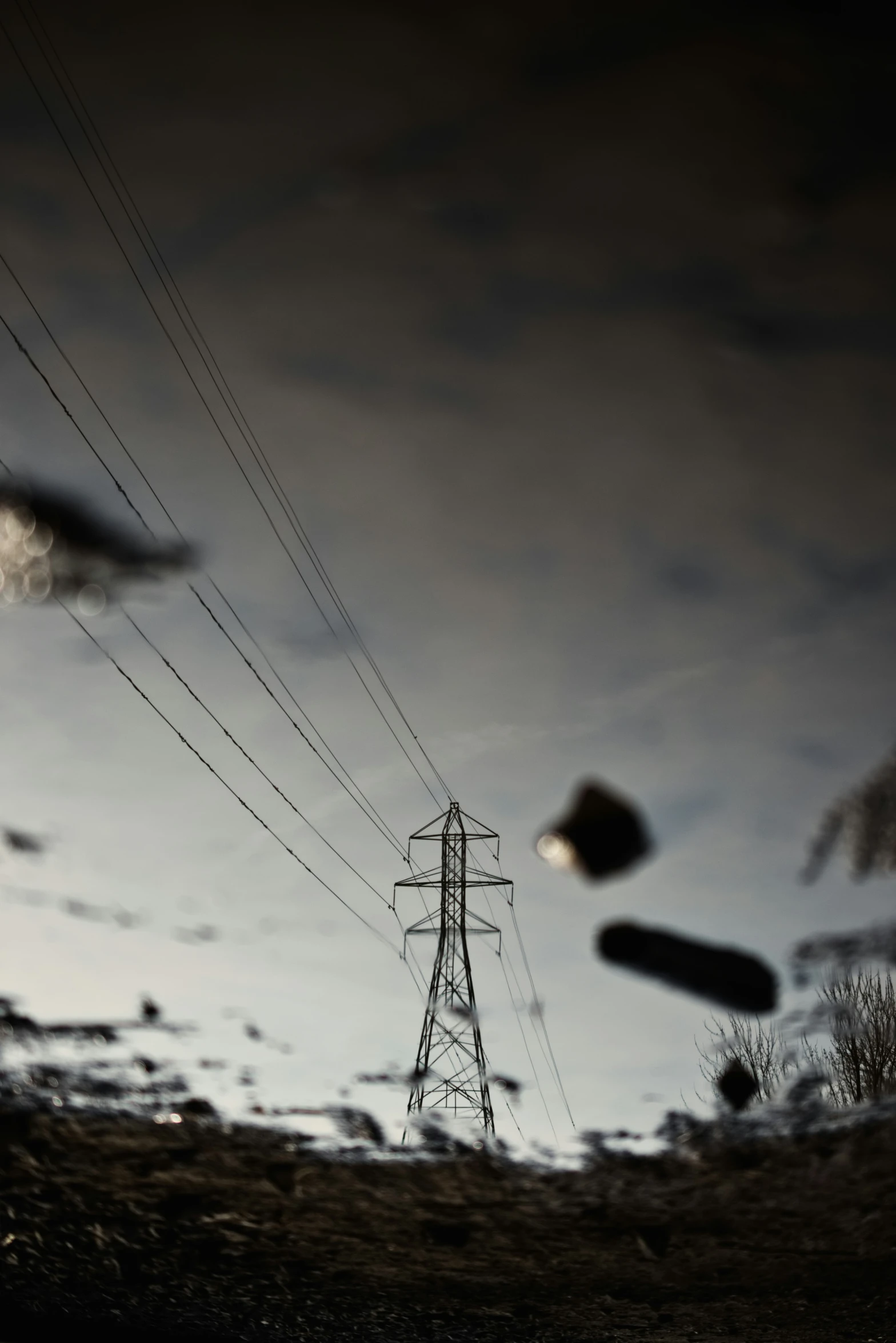 an electric pole and power lines against a partly cloudy sky