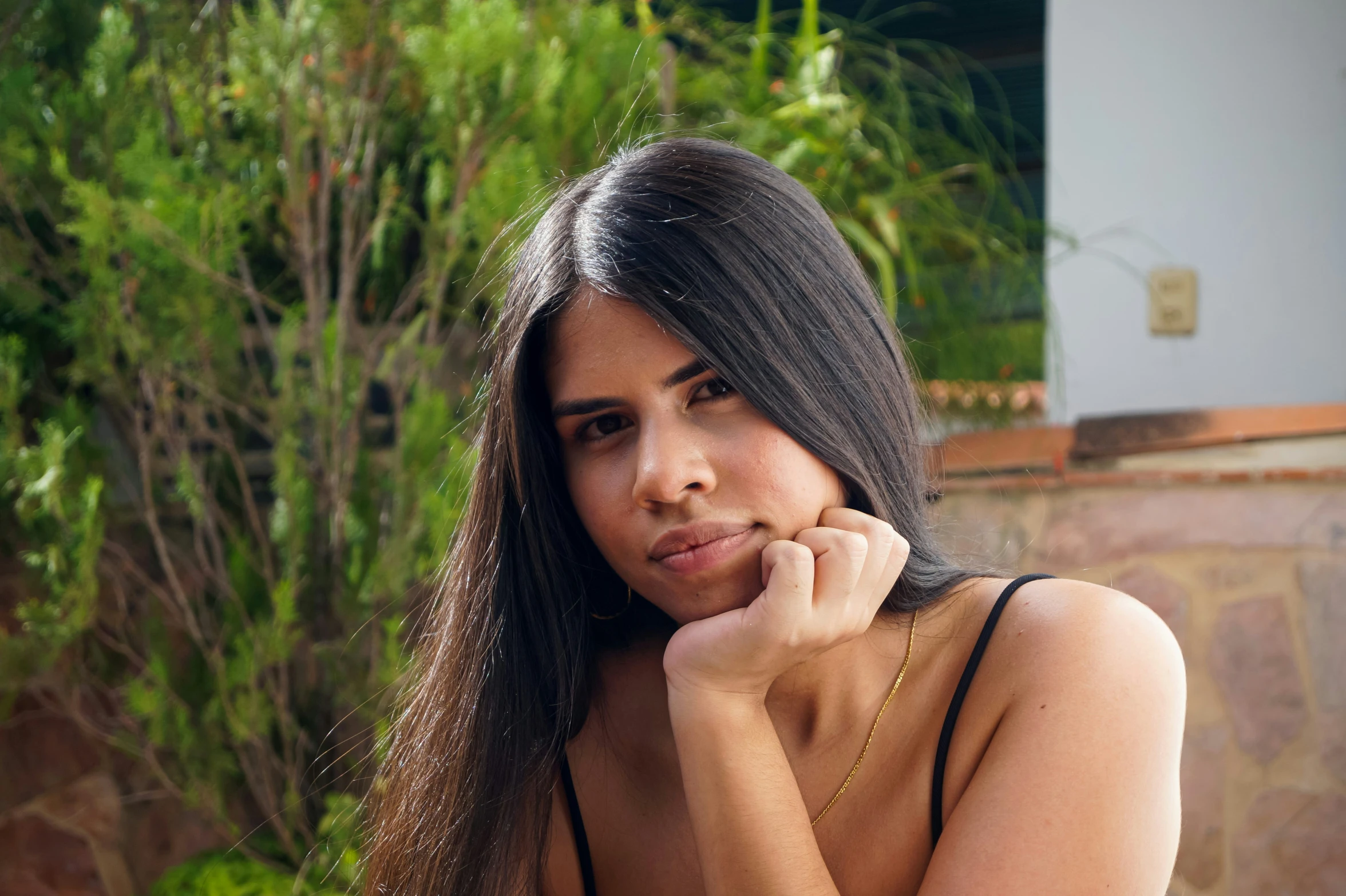 a woman that is sitting down in a black dress