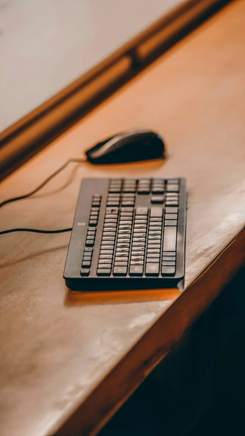 a small computer mouse sitting on top of a wooden table