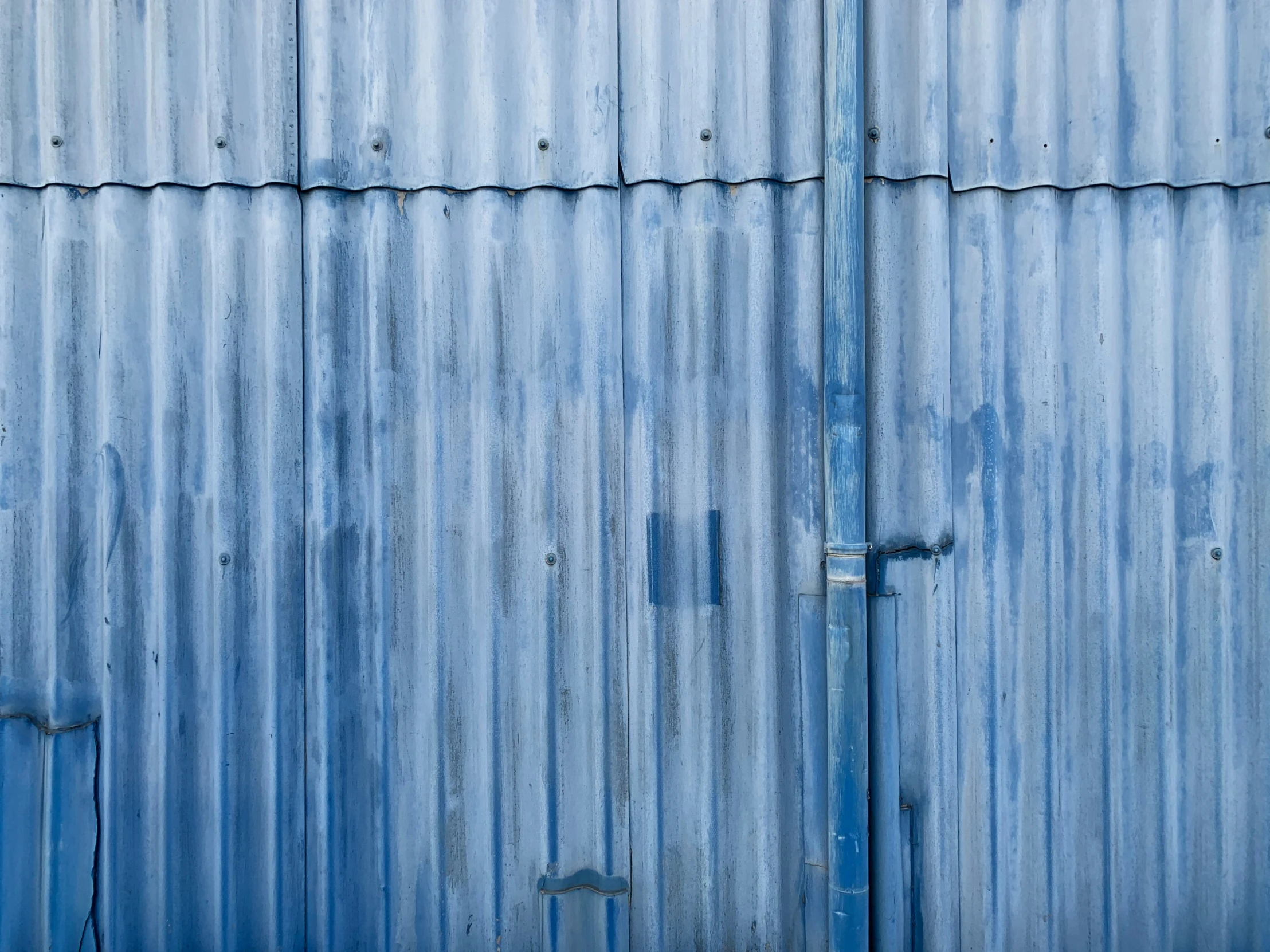 blue wall covered in blue and white metal