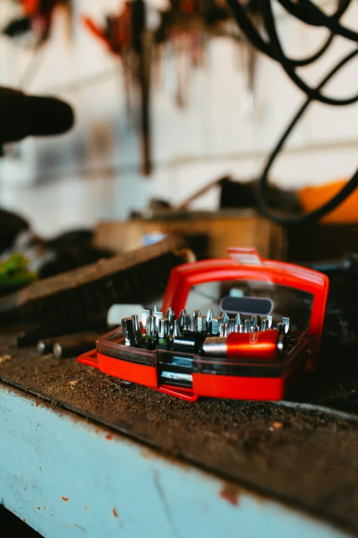 a case is sitting on the table beside other tools