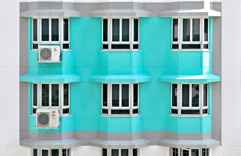 a building has multiple windows and a clock on it