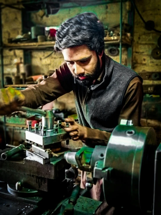 man in the process of working a machine