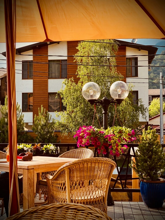 a table and chairs with an umbrella on a balcony