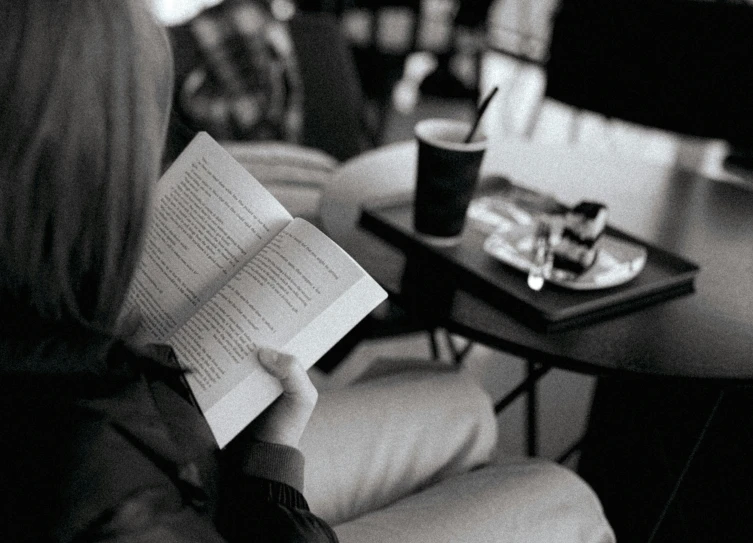 a woman reads a book in a public place