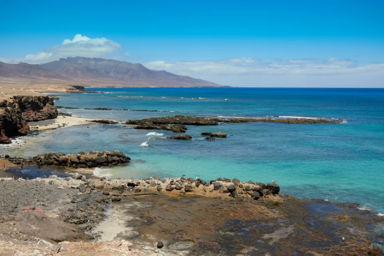 the beach has rocky rocks and clear water