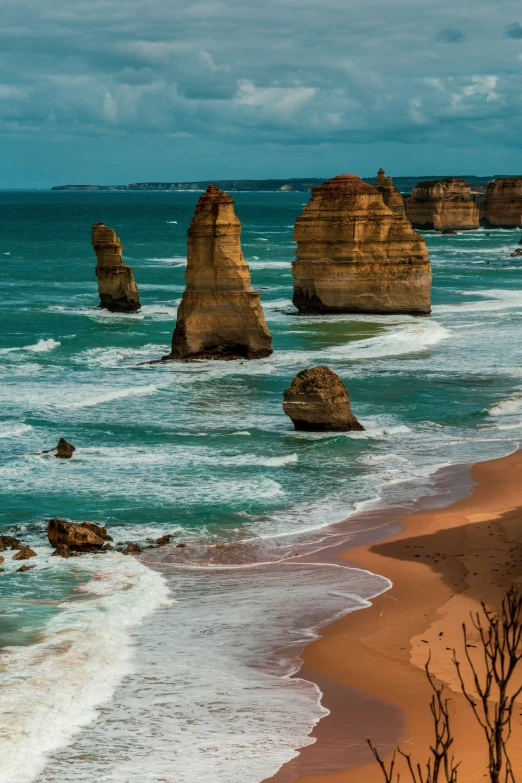 ocean waves hitting the shoreline with some large rocks