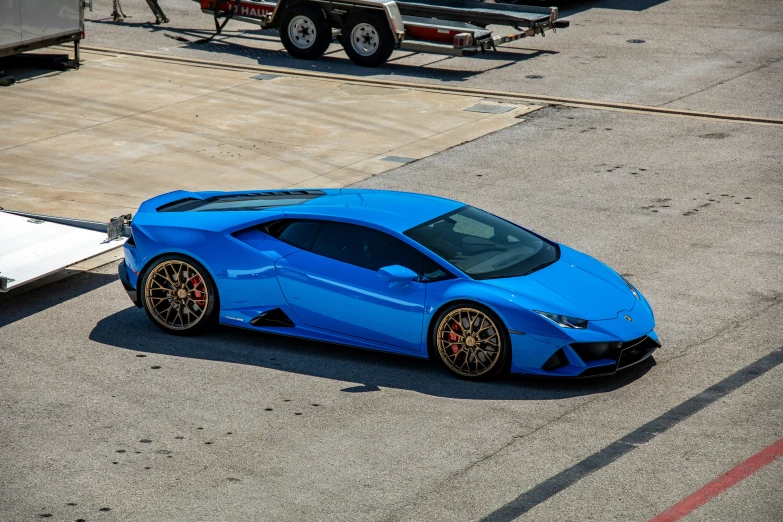 a blue sports car parked in a parking lot