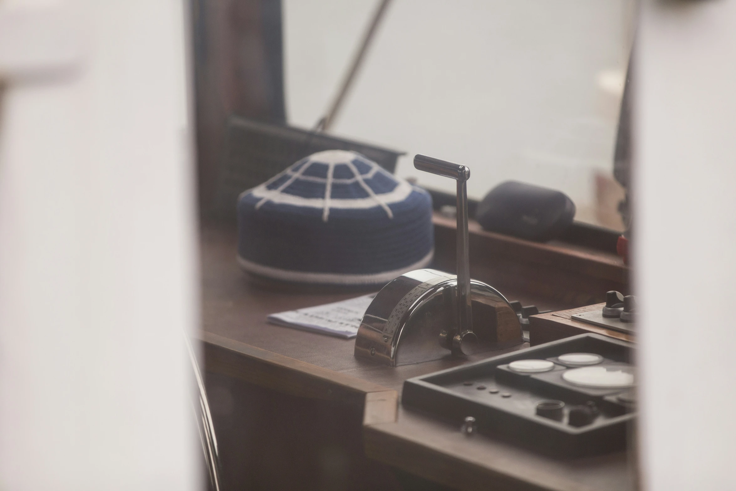 a close up of a desk with a speaker and remote control