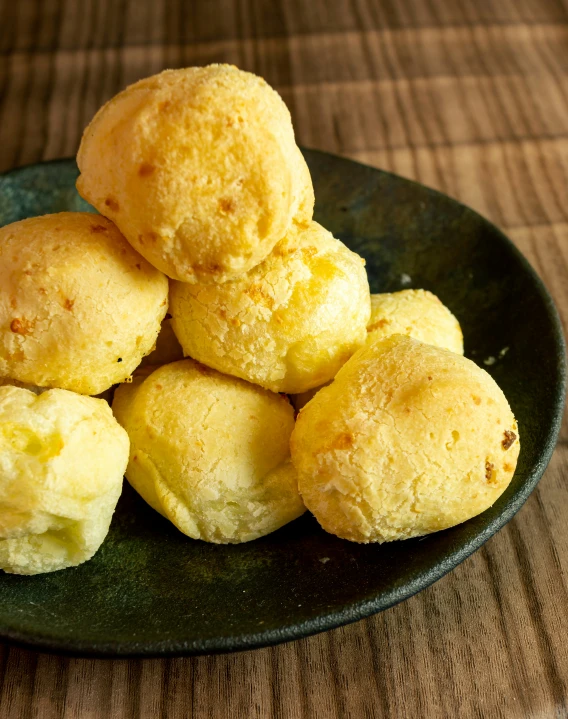 yellow balls of bread arranged on a plate