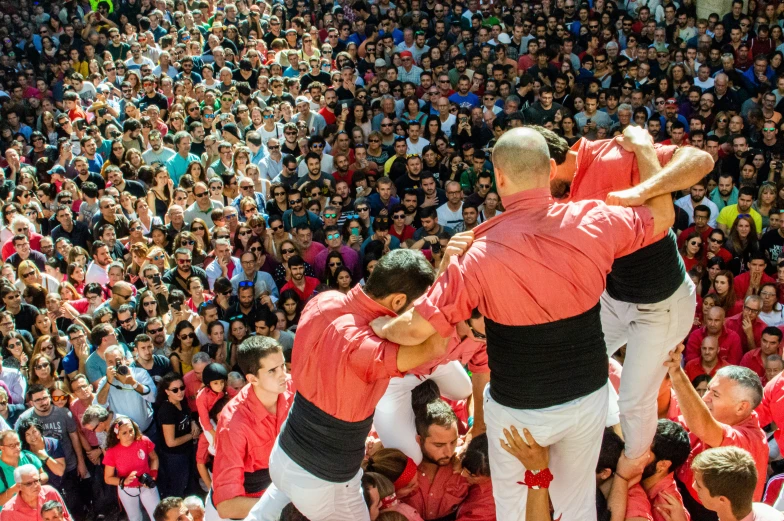 three men in white and orange pants are doing a dance