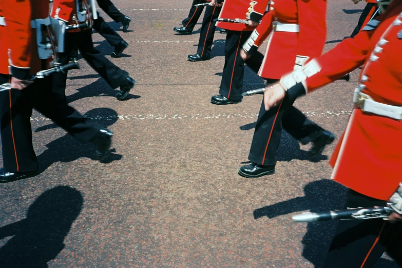 some men in red and black uniforms marching