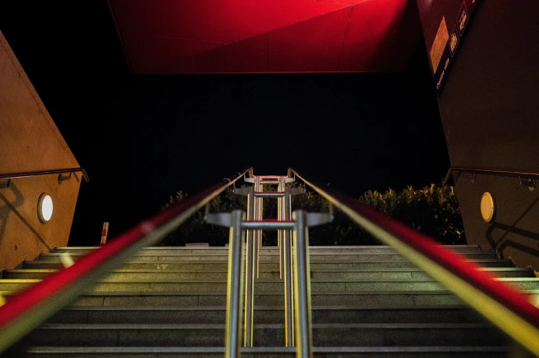 stairs leading up a ramp that is lit by red light