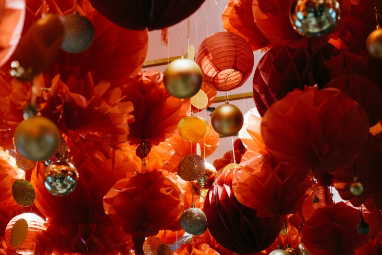 red paper flowers and hanging balls in the shape of flowers