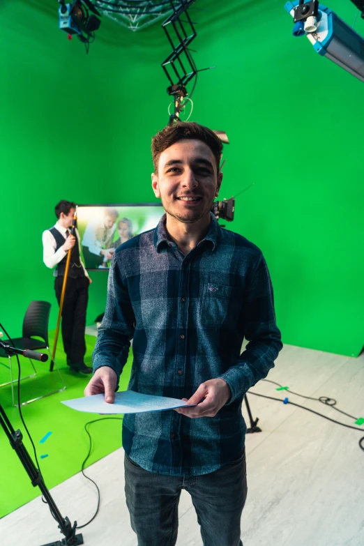 a man holding paper in front of the camera