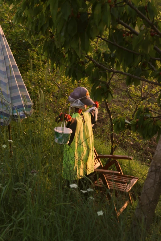 a woman sitting on a wooden bench under a tree