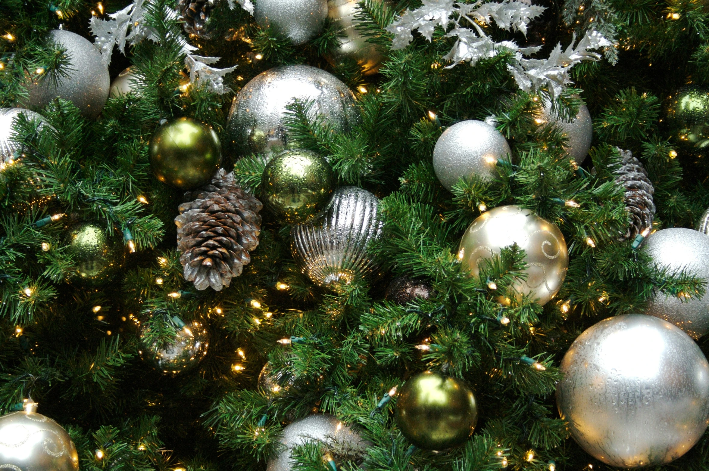 shiny christmas balls and ornaments are on the christmas tree