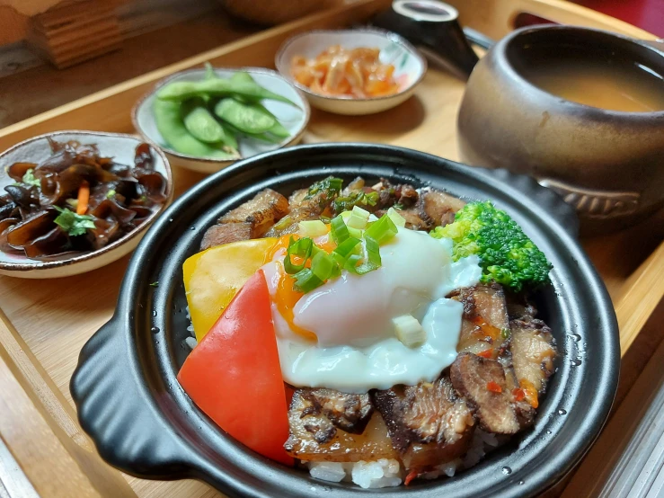 plate full of meat, fruit and vegetables served on wood tray