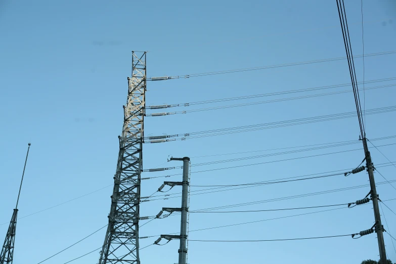 several electrical towers sitting high in the sky