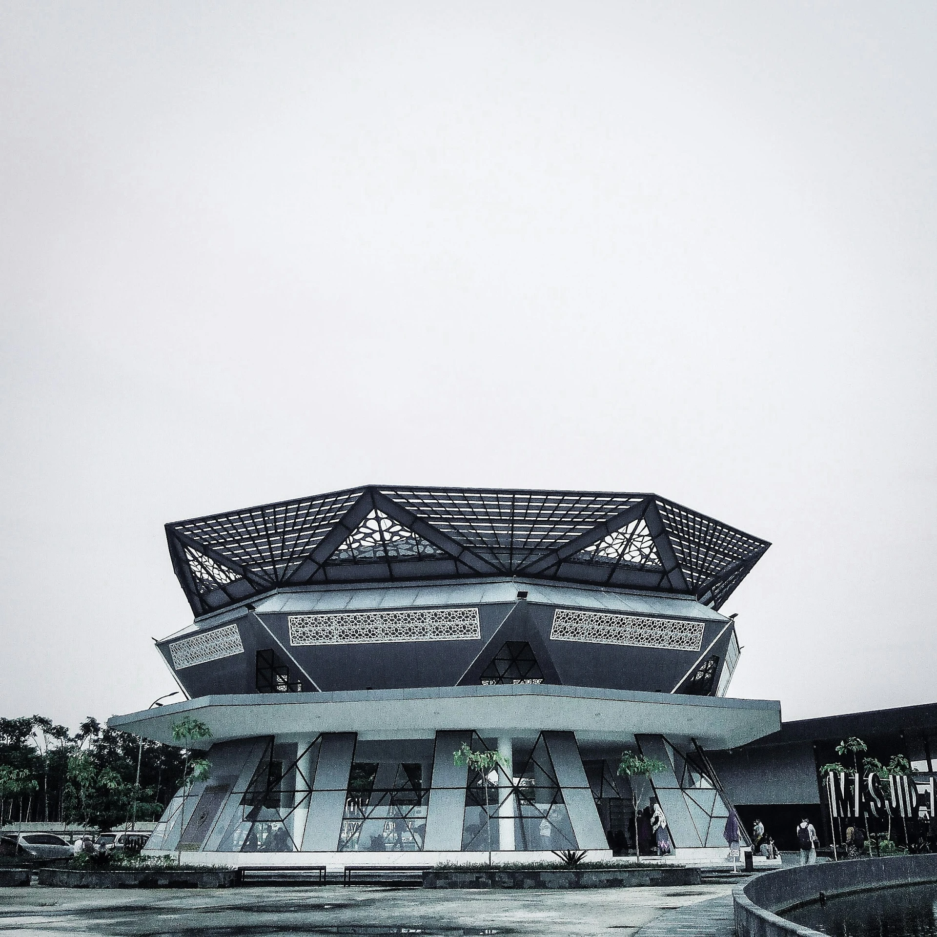 a white building with a massive fan of windows