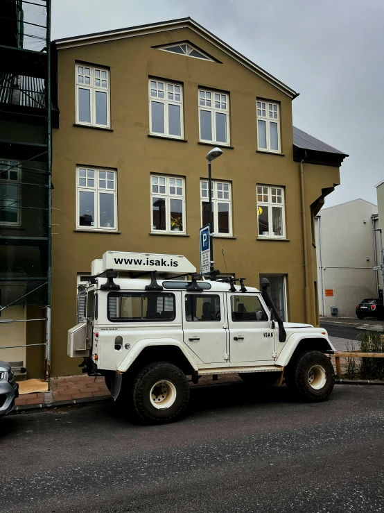 a very large four wheel drive truck parked near a building