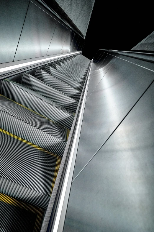 looking down an escalator to the ground with many lines and lines on it