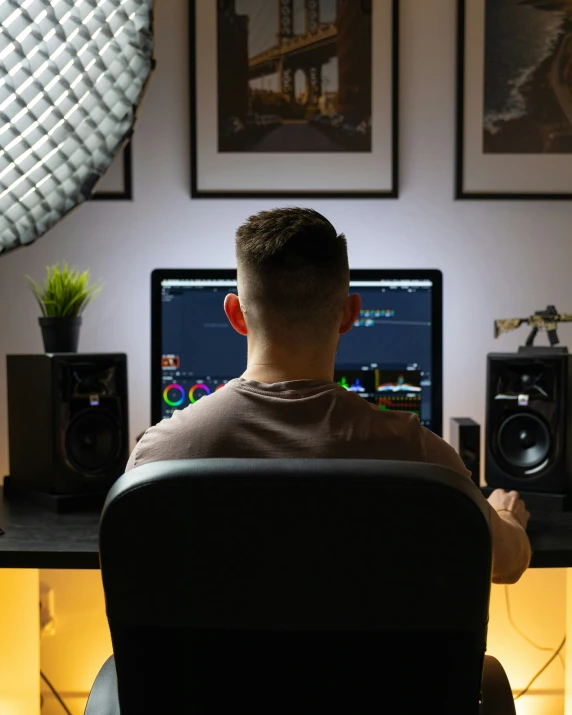 a man is sitting in front of his computer