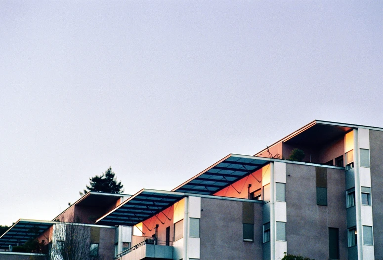 an airplane flying past a building on a clear day