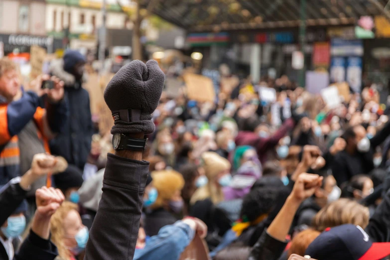 the people in the crowd are holding their hands up