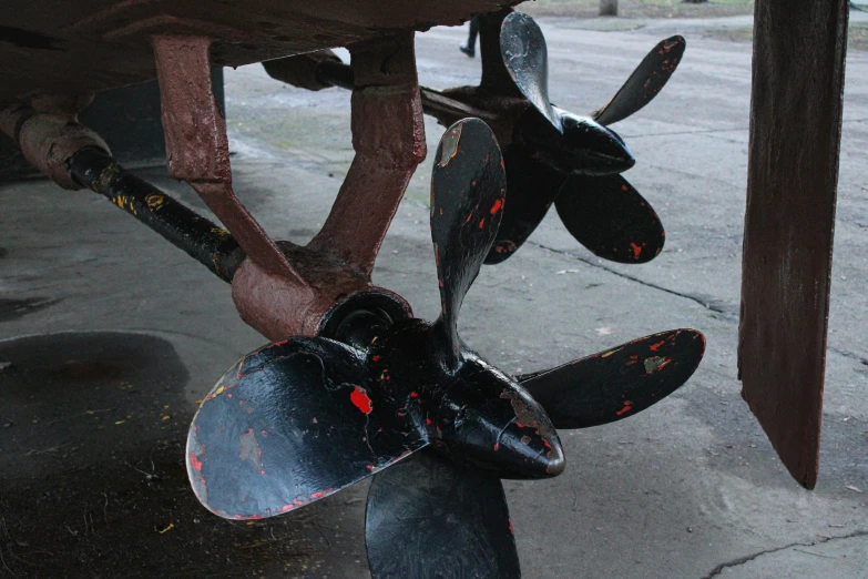 closeup of some metal propeller attached to wood posts