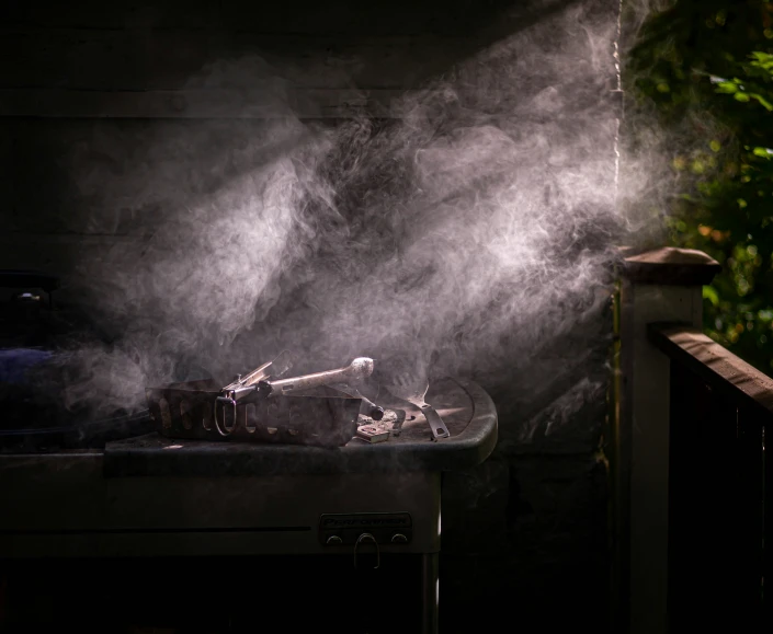 smoke pouring out of the top of a metal pot