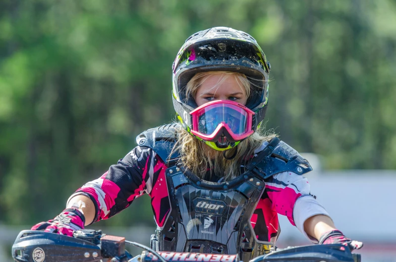 a person in safety gear is on a motorcycle