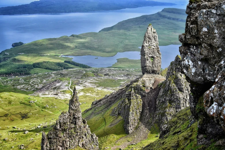 a grassy valley next to a large body of water