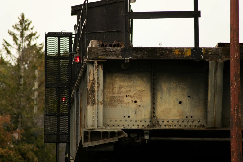 an empty container and an overpass near the trees