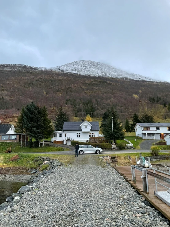 cars parked on the shore next to small houses