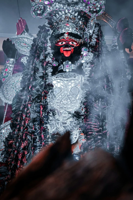 a man with silver paint in an asian costume