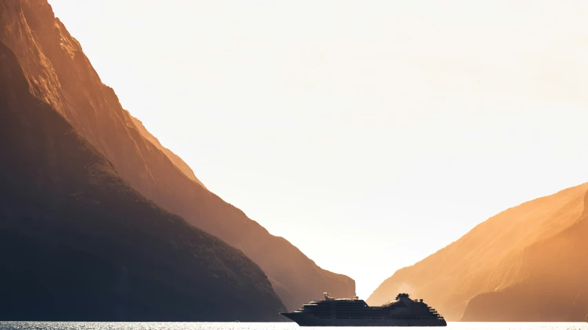 a large cruise ship sails through a canyon